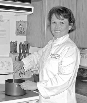 Kim Hildreth prepares food in her Ayer Road home for her business Thyme for Dinner. (Photo by Cyndy Karon) Kim Hildreth prepares food in her Ayer Road home for her business Thyme for Dinner. (Photo by Cyndy Karon)