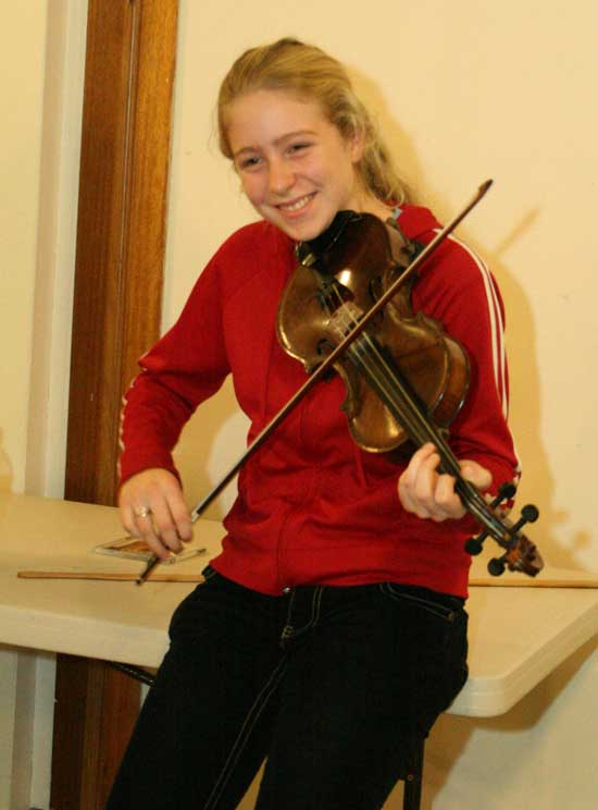 Sarah Collins of Littleton Road plays the fiddle during a sword dance practice at the Unitarian Church.