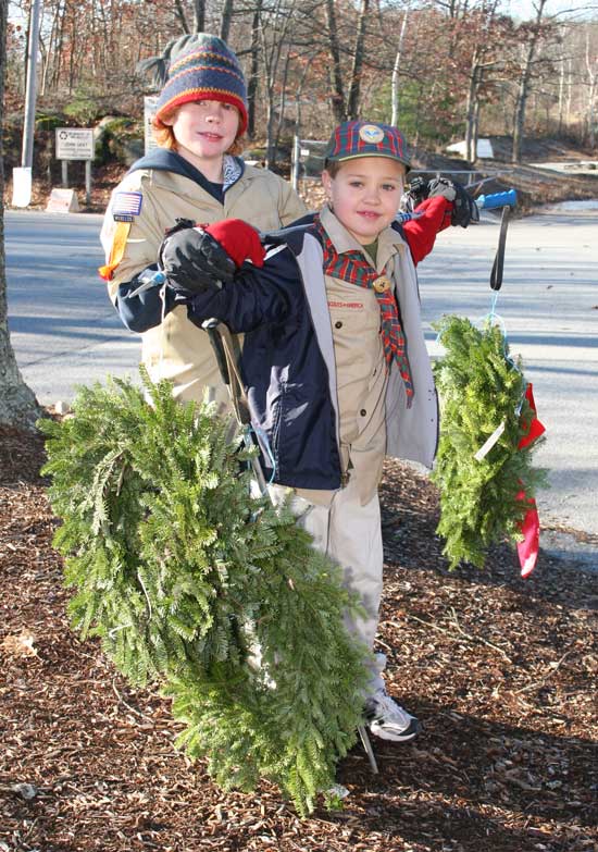 Cub Scouts Tyler Brandom (left) and Ryan Robinson sell Christmas wreaths at the transfer station.