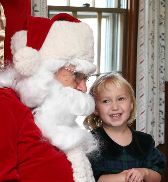 Four-year-old Liza Toll tells Santa that she wants a Webkinz© stuffed animal for Christmas.