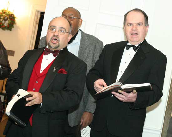 Tenor Ray Bauwens (left) and bass Eric Sossman warm up before taking the stage at the annual Messiah Sing at the Unitarian Church.