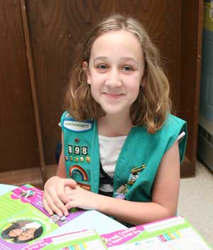 Cassie Ostertag looks over her cookie order sheets and the prizes she’ll be eligible for after selling more than 600 boxes of Girl Scout cookies. (Photo by Lisa Aciukewicz)