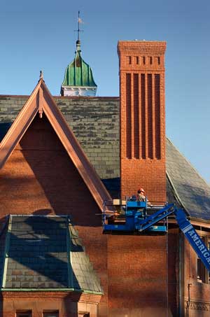 A painter puts finishing touches on the library exterior. (Photo courtesy of Charles Kronauer) A painter puts finishing touches on the library exterior. (Photo courtesy of Charles Kronauer)