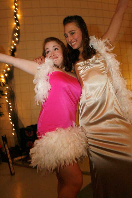 Allison Quinty, left, with her friend Kylie Gordon, shows off the feathered dress she made especially for the Snowball. 