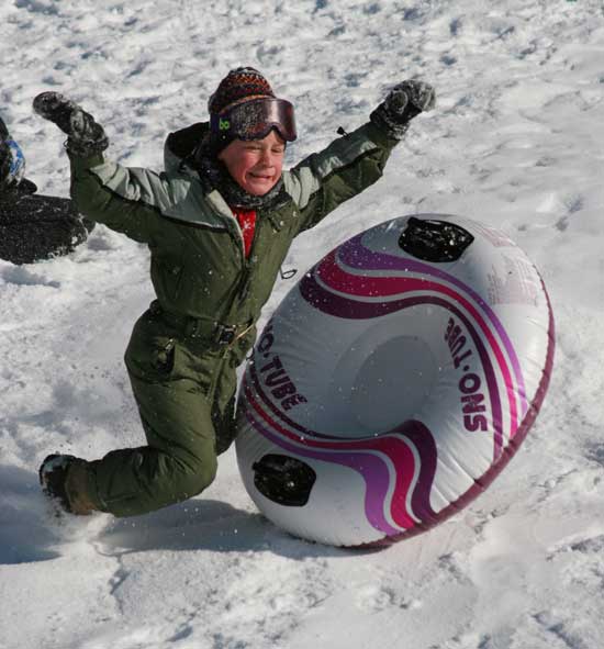Peter Shelton flies off his snow tube as he hits a jump on the hill behind Bromfield.