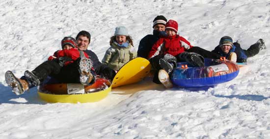 Left to right: Alex and Darren Magan, and Kaeli, Bob, Will, and Jack Armstrong make a wide path as they head down hill together.