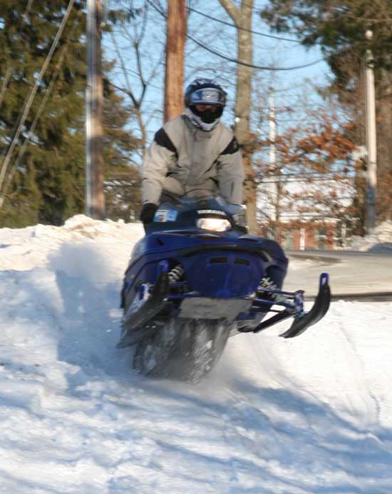 Gary Innamorate of Bolton catches air with his snowmobile on the snowmobile trail on Pond Road.