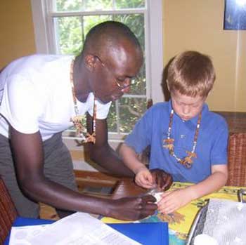 Joseph Kivaa helps Will Carley with a craft project during Astrolabe Farm's summer camp. (Courtesy photo)