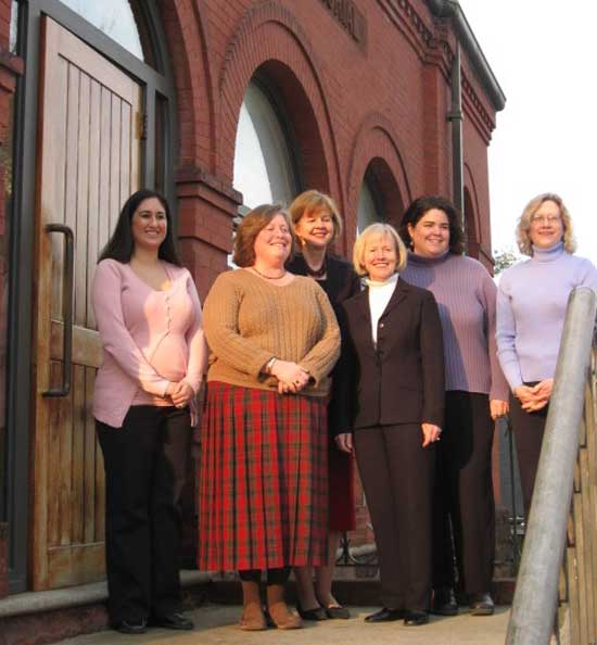 Librarians Nicole Blankenshop, Debbie Garfield, Judy Veno, Mary Wilson, Nicole Luca, and Abby Kingsbury pose on the steps of the old library. (Photo by Laura Andrews)