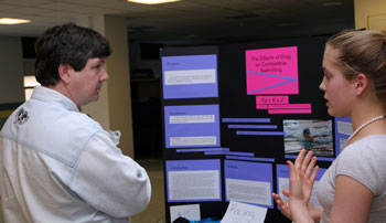 Elizabeth Smentana presents her project, “The Effects of Drag on Competitive Swimming,” to judge Mike Kilian. (Photo by Rob Williams) Elizabeth Smentana presents her project, “The Effects of Drag on Competitive Swimming,” to judge Mike Kilian. (Photo by Rob Williams)