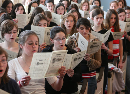 The alto section of the 260-voice chorus rehearses in the Congregational Church.