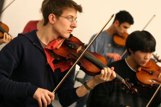 Estlin Usher of Shoreham, Vermont, plays first violin with the orchestra.
