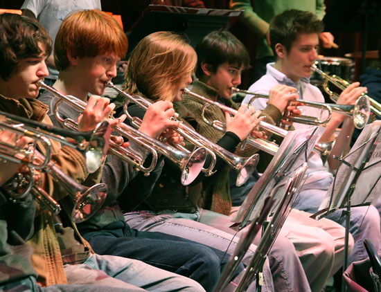 In Cronin Auditorium, the trumpet section, including Bromfield’s Timothy Smetana (far left), performs with the band.