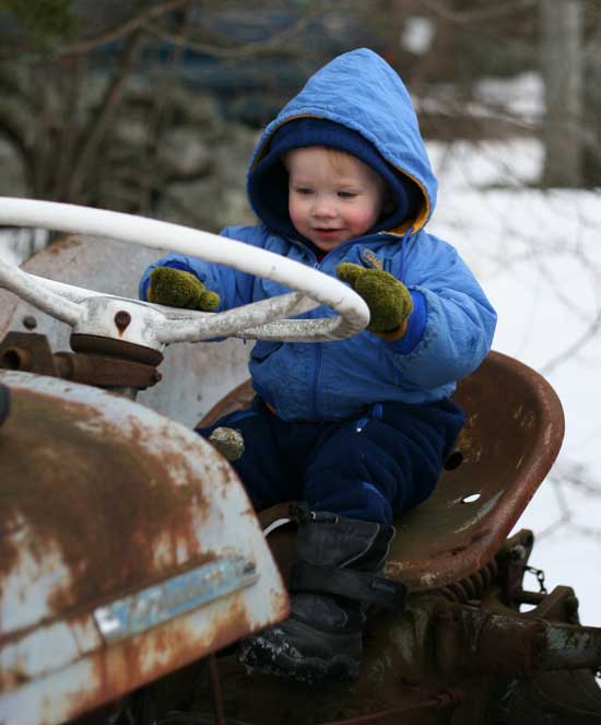 Twenty-two-month-old Harry Burns entertains himself on a tractor at Bob Moran’s while his dad checks his sap buckets Twenty-two-month-old Harry Burns entertains himself on a tractor at Bob Moran’s while his dad checks his sap buckets