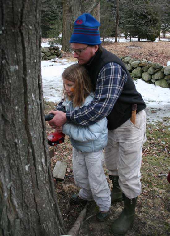 Gwyneth Burns gets a little help from her dad as she drills a hole for a tap. Gwyneth Burns gets a little help from her dad as she drills a hole for a tap.