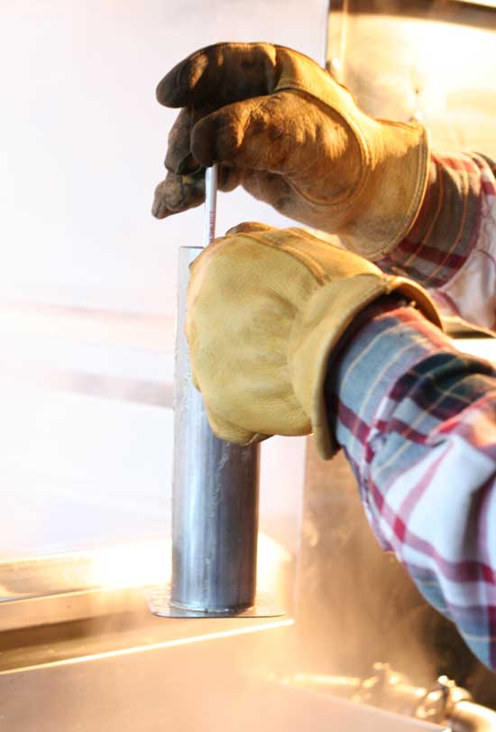 Jim Burns uses a hydrometer to test the density of his syrup. Syrup that is too thin is more likely to spoil and will be weak flavored. Syrup that is too dense can crystalize. Jim Burns uses a hydrometer to test the density of his syrup. Syrup that is too thin is more likely to spoil and will be weak flavored. Syrup that is too dense can crystalize.