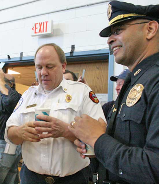 Fire Chief Bob Mignard chats with Police Chief Ed Denmark. 