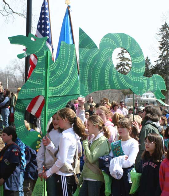 The libary's dragon mascot is carried to the ceremony.