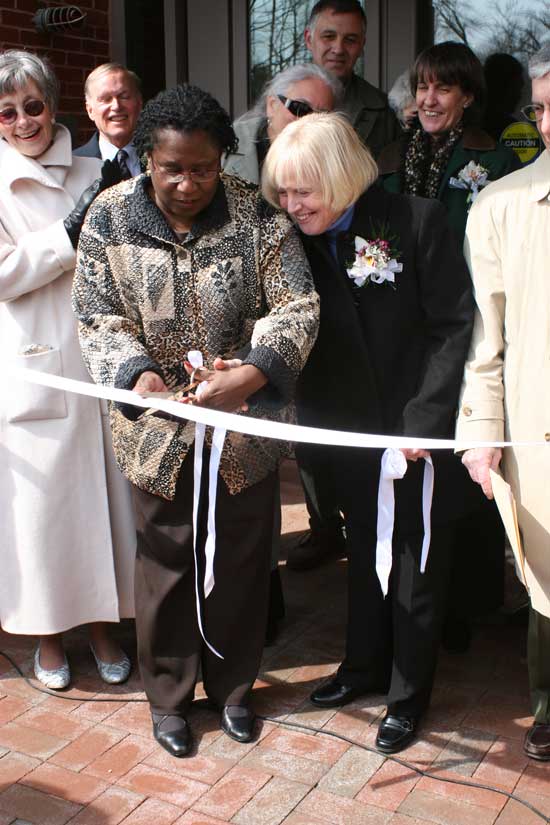 Chairwoman of the Massachusetts Board of Library Commissioners Dr. Em Claire Knowles helps Library Director Mary Wilson cut the ribbon on the new library.