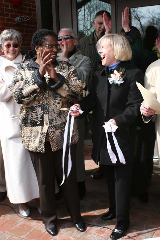 Chairwoman of the Massachusetts Board of Library Commissioners Dr. Em Claire Knowles helps Library Director Mary Wilson cut the ribbon on the new library.