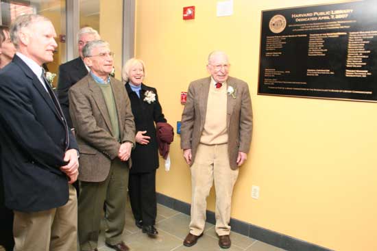 Pete Jackson (left), Roy Moffa, Mort Miller, and Mary Wilson stand by as Jeff Harris unveils the plaque in the new library's lobby.