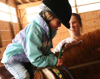 Kala Bishop practices a jumping position as her teacher, Faye Miller, watches. (Photo by Lisa Aciukewicz) Kala Bishop practices a jumping position as her teacher, Faye Miller, watches. (Photo by Lisa Aciukewicz)