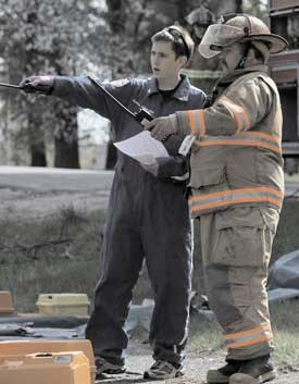 Ambulance squad member Sean Doocey (left) and firefighter Tony Shaw strategize during last year’s mock accident at Bromfield. (Photo by Rob Williams) Ambulance squad member Sean Doocey (left) and firefighter Tony Shaw strategize during last year’s mock accident at Bromfield. (Photo by Rob Williams)