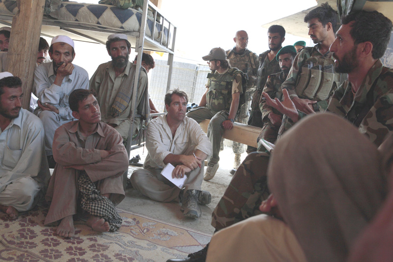 Charlie Sennott (center) on assignment for the Boston Globe in Kunar province listens to a conversation between the Afghan National Army and people from a village where insurgent attacks have been launched. (Courtesy photo) Charlie Sennott (center) on assignment for the Boston Globe in Kunar province listens to a conversation between the Afghan National Army and people from a village where insurgent attacks have been launched. (Courtesy photo)
