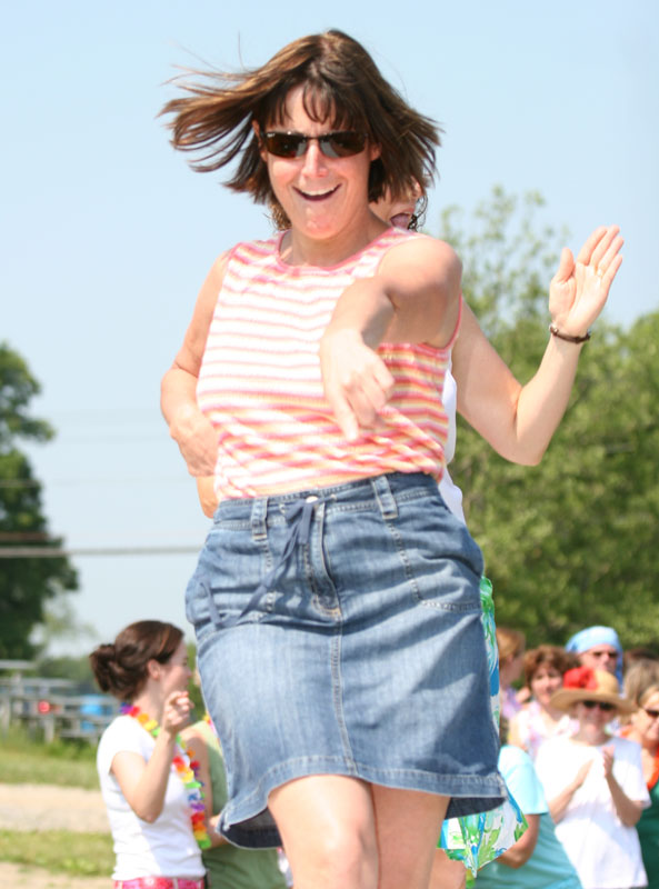 Elementary school Principal Mary Beth Banios good humoredly takes center stage on the dance floor at the Hawaiian luau.