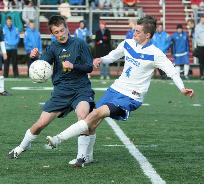 Lynnfield’s Alex MacEachern braces himself as Bromfield’s Sam Peisch sends the ball down field. 