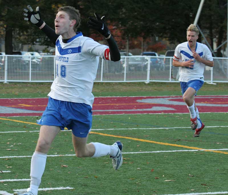 Senior Josh Lyvers (left) runs toward the stands after scoring the winning shot in the boys soccer division III state championship in sudden death overtime as senior Ben Brown shouts in celebration.