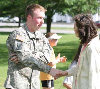 Specialist Farwell shakes hands with troop leader Julie Sniffen