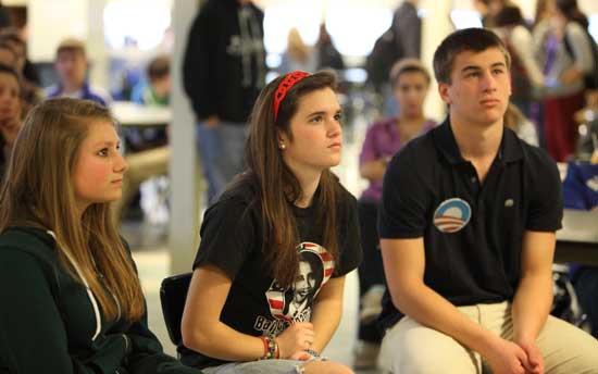 Kristin Tomasello, Grace Tuttle, and Jack Broadbent listen raptly to President Obama's inaugural address in the Bromfield cafeteria.