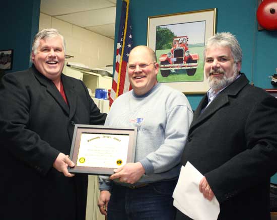 Jim Pinard (left) of the Ayer-Harvard-Shirley Rotary club and John Drummey (right) representing the Harvard Lions Cllub present electrician Dave Woodsum with a community service award in March for his role in clearing the roads after the December 2008 ice storm.