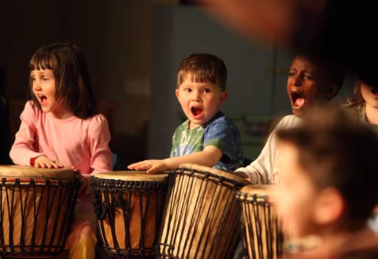 Kindergartener Ethan Taylor (center) performs with the group Rhythm Kids.