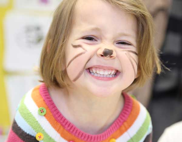 Campbell Phillips shows off her freshly painted kitty face at the Harvard Family Association Egg Hunt.