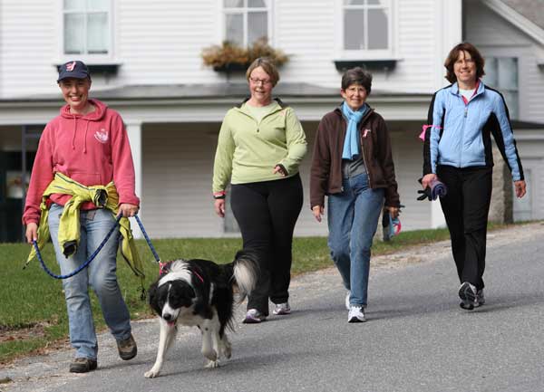 Helen Hill, Deb Small, Pam Durrant, and Ann Whitney walk down Madigan Lane during the Good Friday Walk held to benefit Loaves & Fishes. The women were with a larger group from Harvard and Bolton that will be walking in the three-day Just ’Cause walk to raise money for breast cancer organizations in May. The group traditionally uses the Good Friday Walk as a warmup for its 60-mile event.