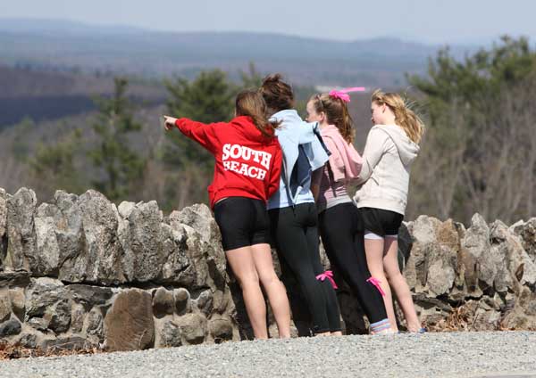 Lily Alfano, Miranda DeGuglielmo, Kiley Nygren, and Montana Burke take in the view at Prospect Hill while taking a break during the Good Friday Walk.