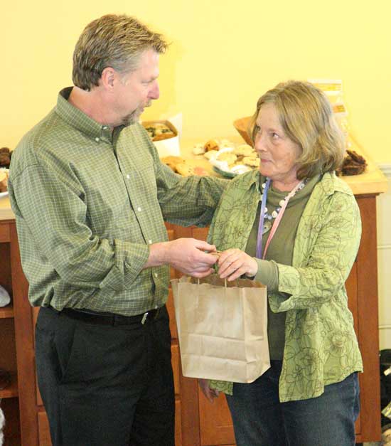 Fruitlands incoming CEO Tim Firment gives Maud Ayson, who served as executive director since 2000, a gift