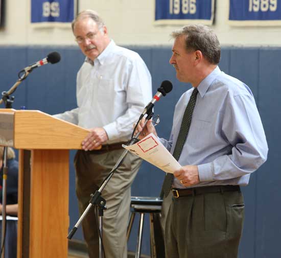 Moderator Bob Eubank listens to Schools Superintendent Tom Jefferson explain a school budget item.