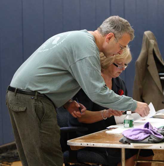 Paul Cohen gives a copy of his amendment to Article 23 to Town Clerk Janet Vallente.