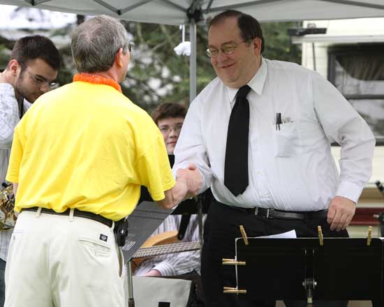 Bill Ennis, incoming president of the Ayer, Harvard, Shirley Rotary Club, presents Bromfield’s Tim Reynolds with a check for the school’s band after the jazz band played at the festival.