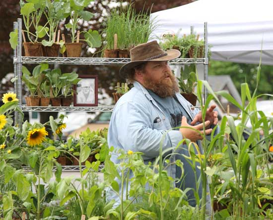 Jim Croyle of Blue Moon Farm on Depot Road sells organic vegetable plants from his booth on the Common.