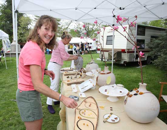 Della Jennings checks out Ania Davis's jewelry at the Apple Blossom Festival.