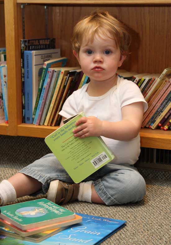 Eighteen-month-old Eleanor Daly of Lancaster can’t get enough of the board books. 