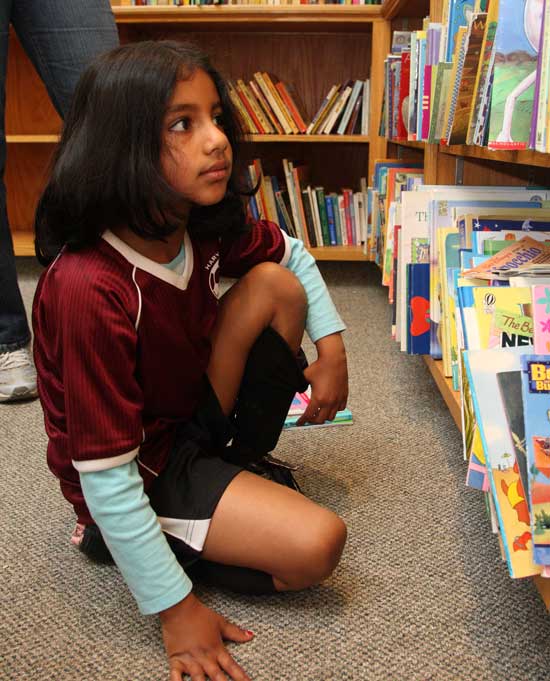  Nikhil Kommineni scans the large choice of children's books.