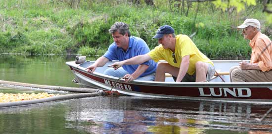 From left: Rotary Club members Pat Magnus, John Gervais, and Paul von Loeseke point out the winning duck. The winner of the race receives dinner anywhere in the world that he or she chooses. This year’s winner was Ernie Hills of Pepperell.