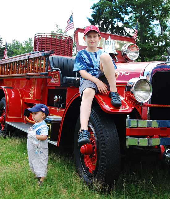Noah and Thomas Berthoud relax on an old pumper truck. (Photo by Tyler Mitchell) 