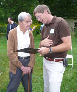 Tim Clark presents Erhart Muller with a proclamation from Harvard's Board of Selectmen Tim Clark presents Erhart Muller with a proclamation from Harvard's Board of Selectmen