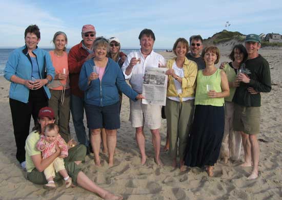 Mary Ellen (fifth from right) and Steve Miller (center) of Littleton Road celebrate their 25th wedding anniversary on the beach in Truro, Cape Cod, with friends, including the Harvard Press. 